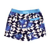 Boys blue and white geometric swim shorts with ice cream cone print in eco-friendly greige polyester. Blue drawstring waistband with brand logo & secure velcro pocket at the back