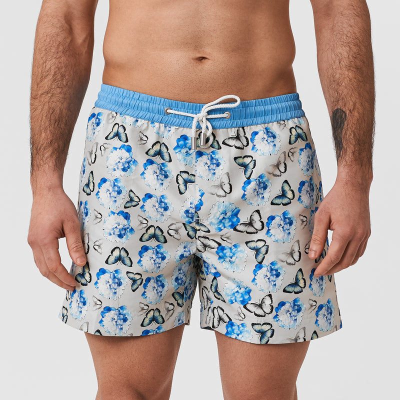 Grey mens swim shorts with blue butterfly pattern and blue waistband