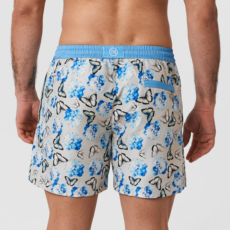 Light grey matching mens and boys swim shorts with blue butterfly pattern and blue waistband
