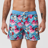 Male model wearing Thomas Royall blue swim shorts with pink butterflies